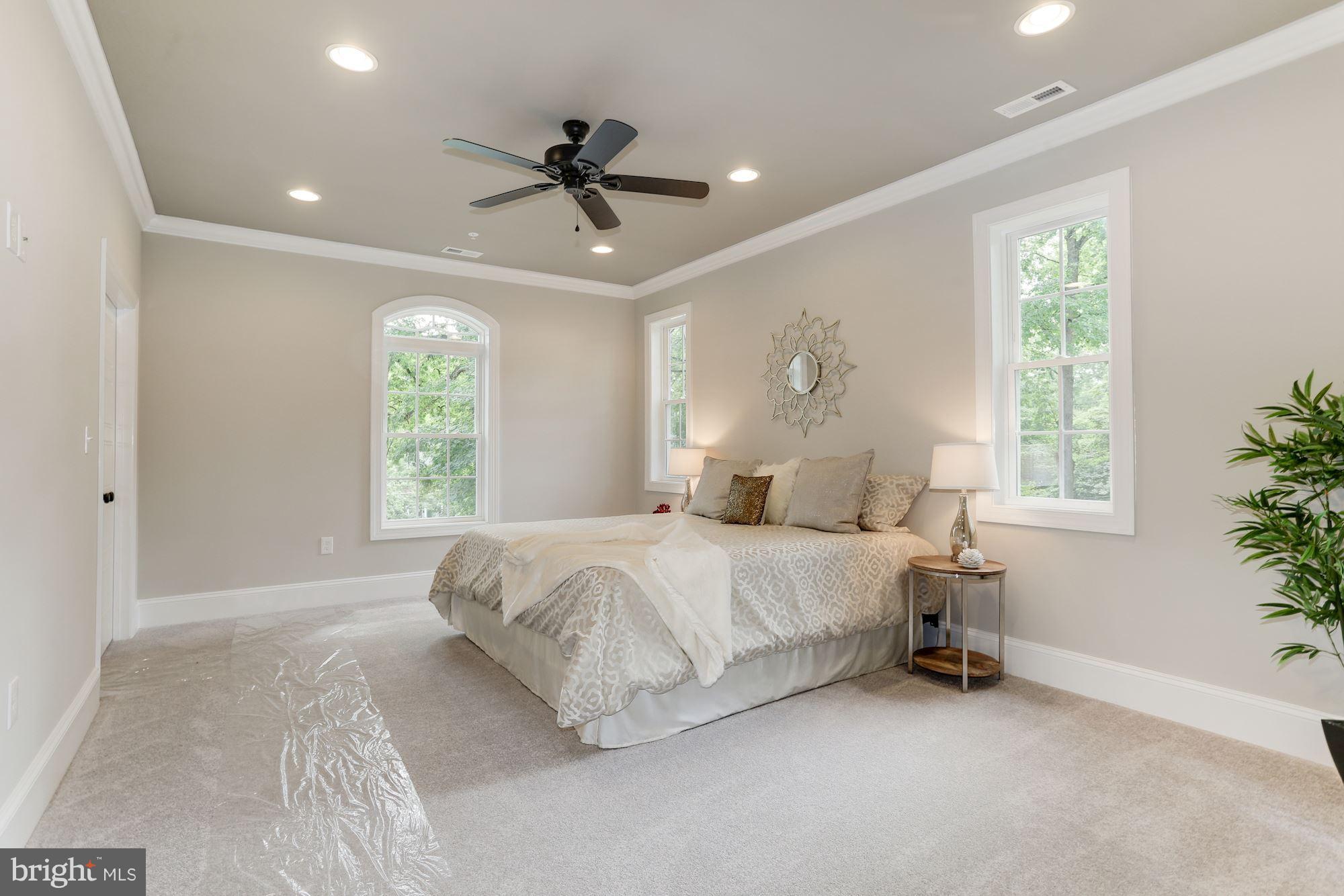 507 South Rolling Road Baltimore, MD 21228 - Photo 17 of 30 a spacious bedroom with a bed and a chandelier