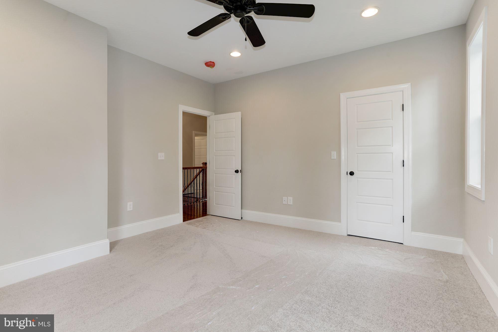 507 South Rolling Road Baltimore, MD 21228 - Photo 25 of 30 an empty room with a ceiling fan and window