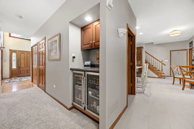 a view of hallway with furniture and a refrigerator