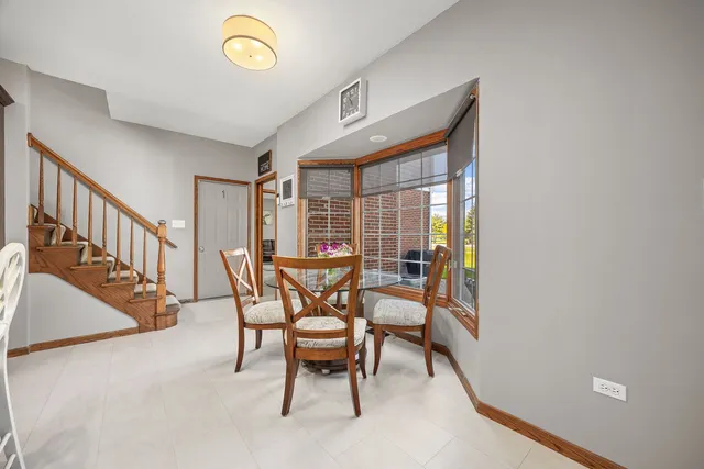 a dining room with furniture and a window