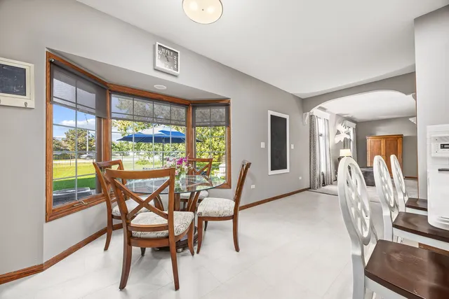a dining room with furniture and a floor to ceiling window