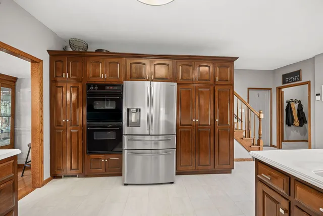 a kitchen with stainless steel appliances granite countertop a refrigerator and a stove top oven