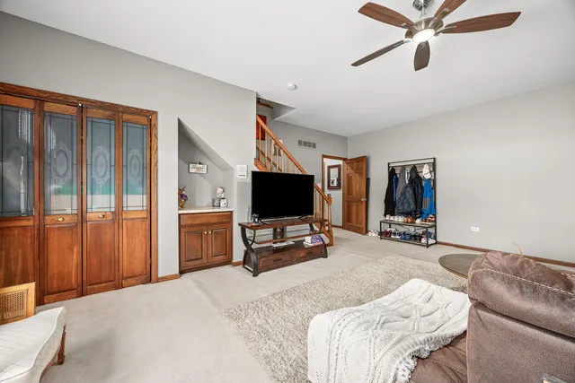 a bedroom with furniture and a flat screen tv