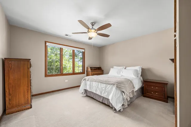 a spacious bedroom with a bed and a large window