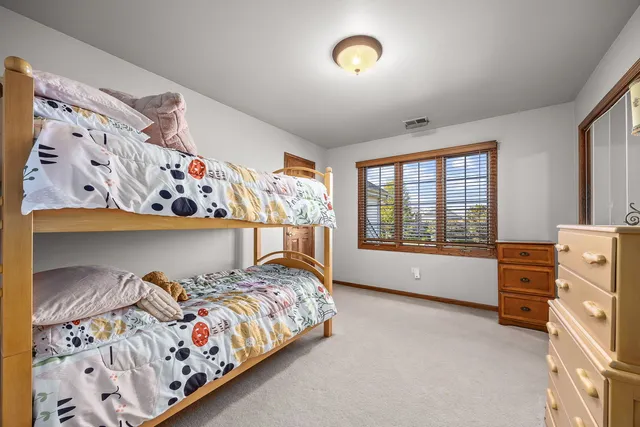 a bed room with a bed and a window