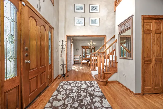 a view of a hallway with wooden floor and furniture