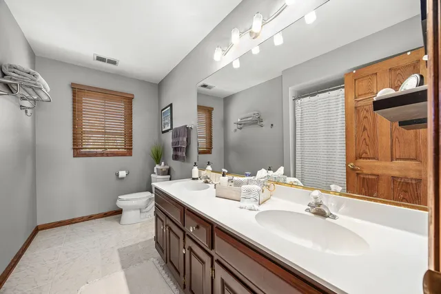 a bathroom with a sink double vanity and a mirror