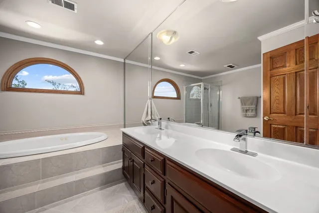 a bathroom with a double vanity sink and a mirror