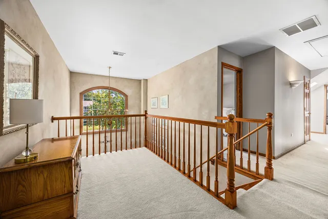 a view of a hallway to a livingroom with furniture