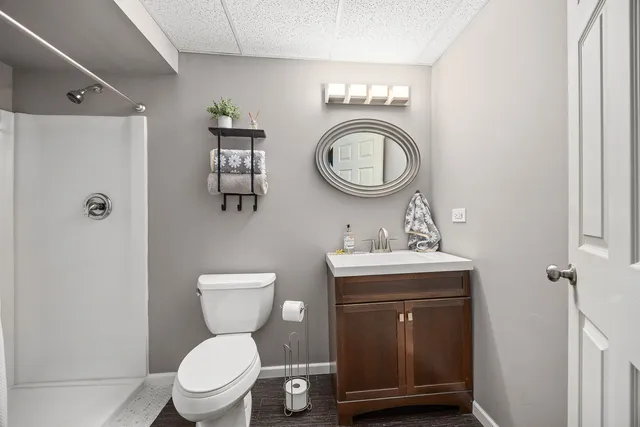 a bathroom with a toilet a sink and a mirror