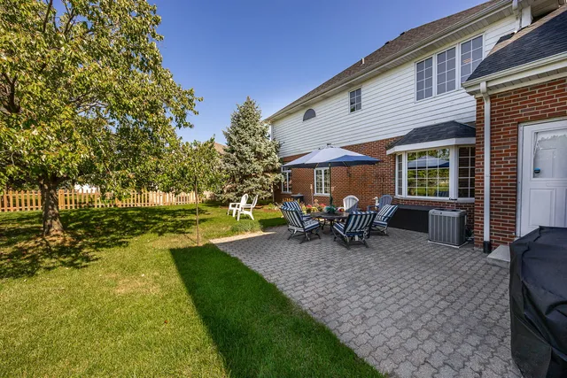 a view of a house with backyard porch and sitting area