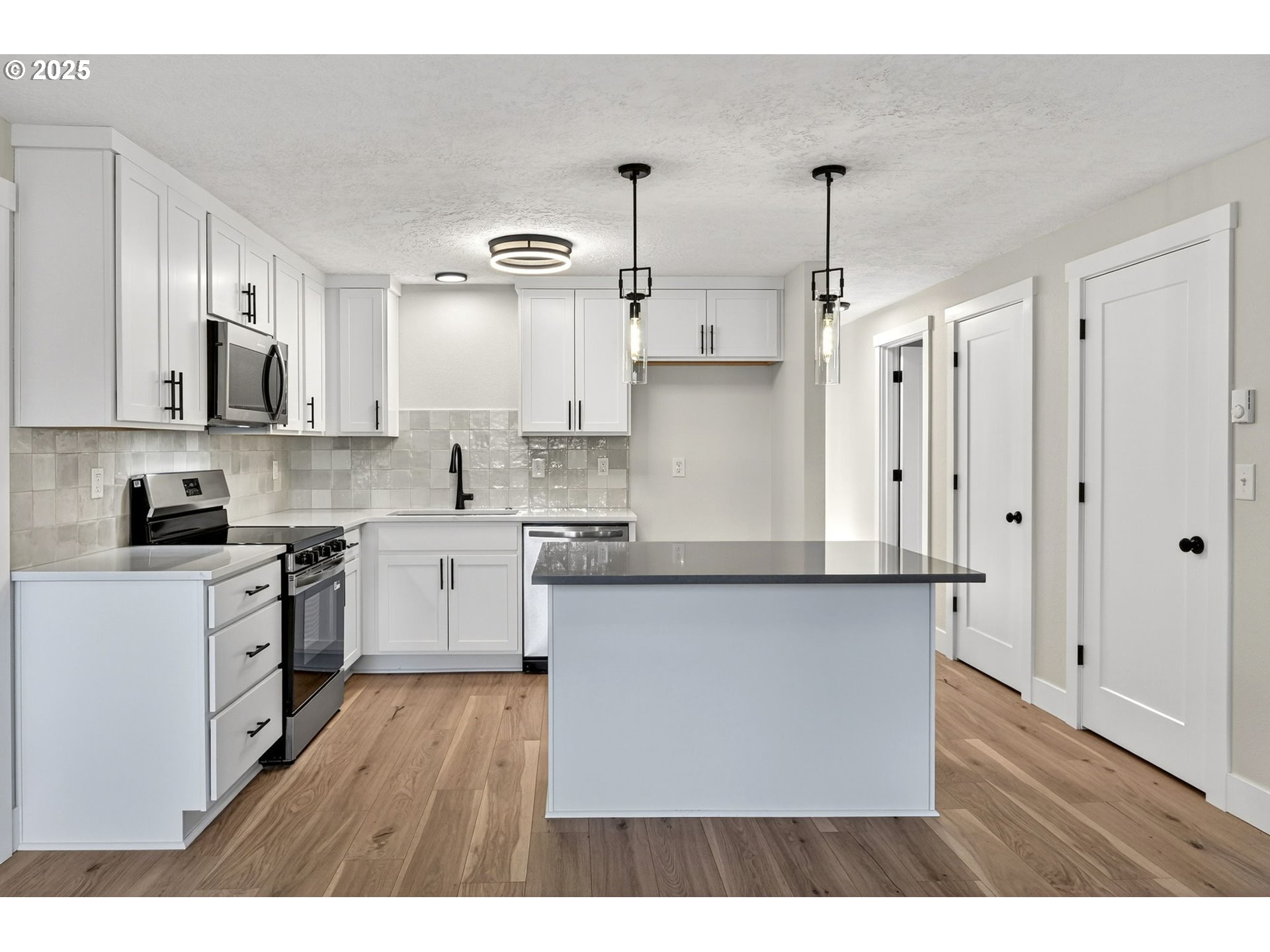 17745 Davis Drive Sandy, OR 97055 - Photo 11 of 44 a kitchen with stainless steel appliances cabinets a sink and a counter top space