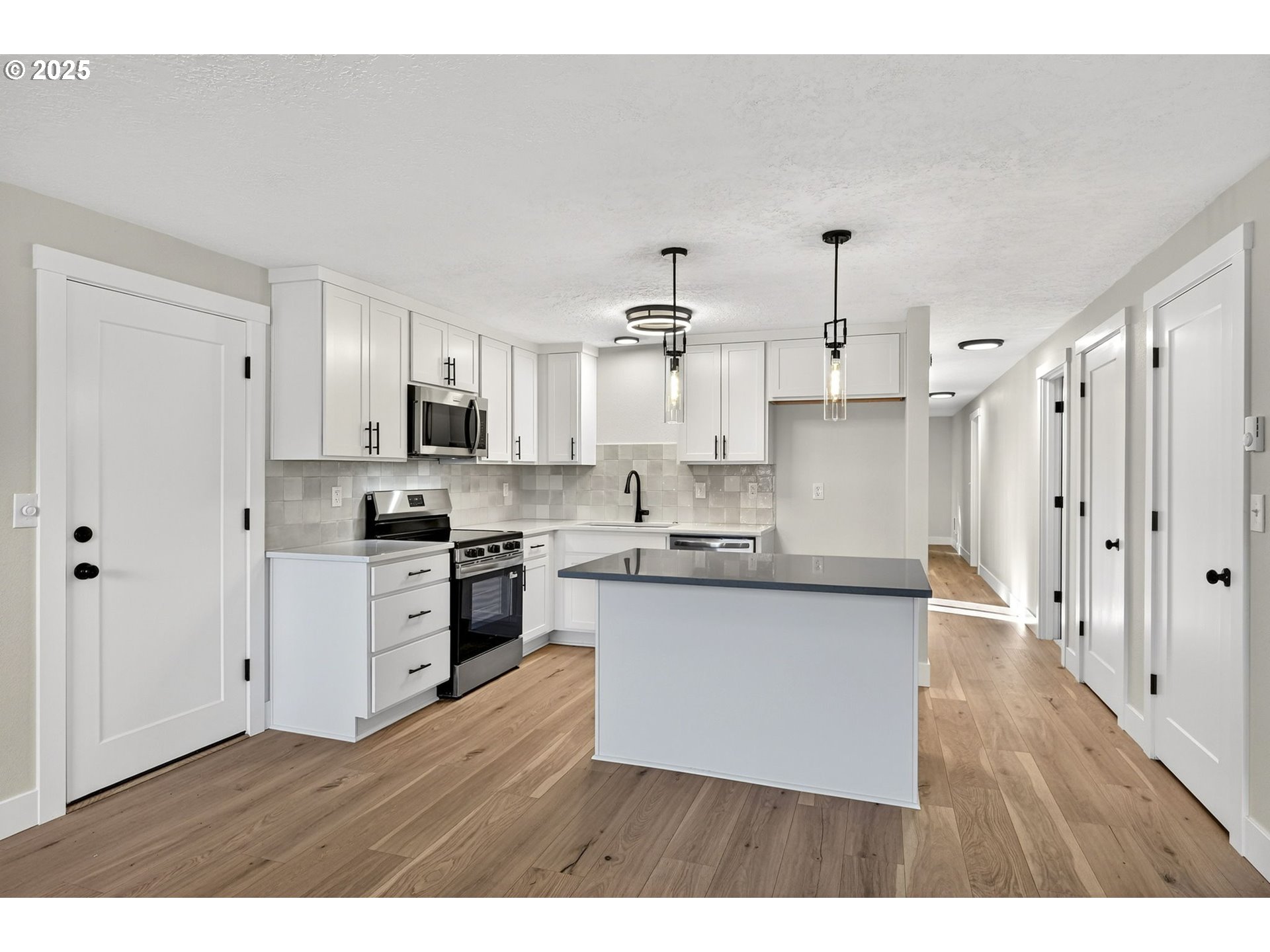 17745 Davis Drive Sandy, OR 97055 - Photo 12 of 44 a kitchen with stainless steel appliances cabinets a sink and a wooden floor