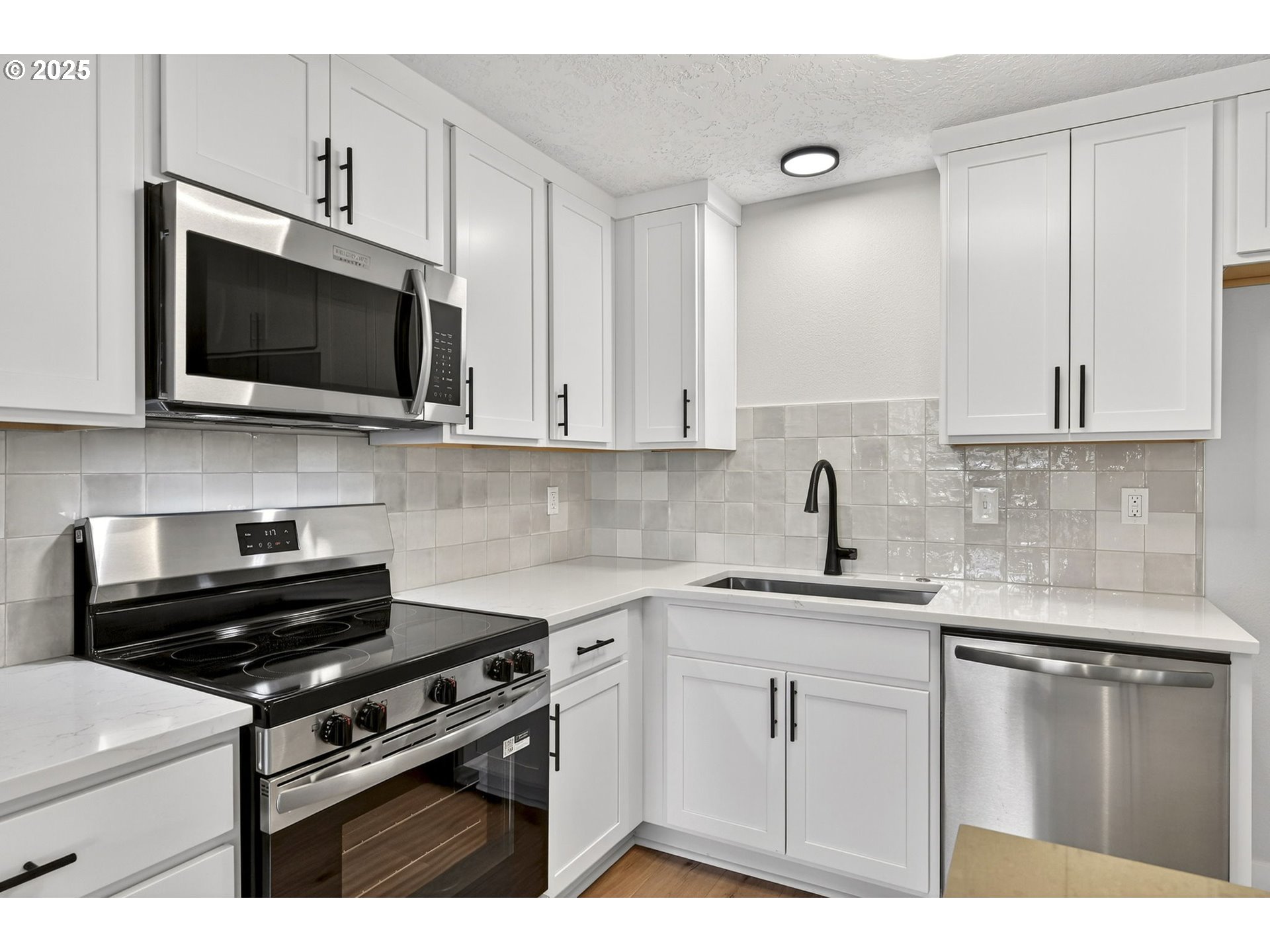 17745 Davis Drive Sandy, OR 97055 - Photo 14 of 44 a kitchen with stainless steel appliances a sink dishwasher stove and microwave