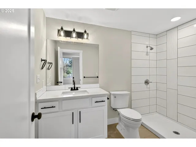 a bathroom with a sink a toilet and mirror