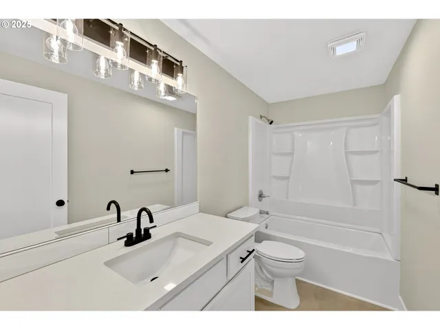 a bathroom with a sink a toilet and a tub