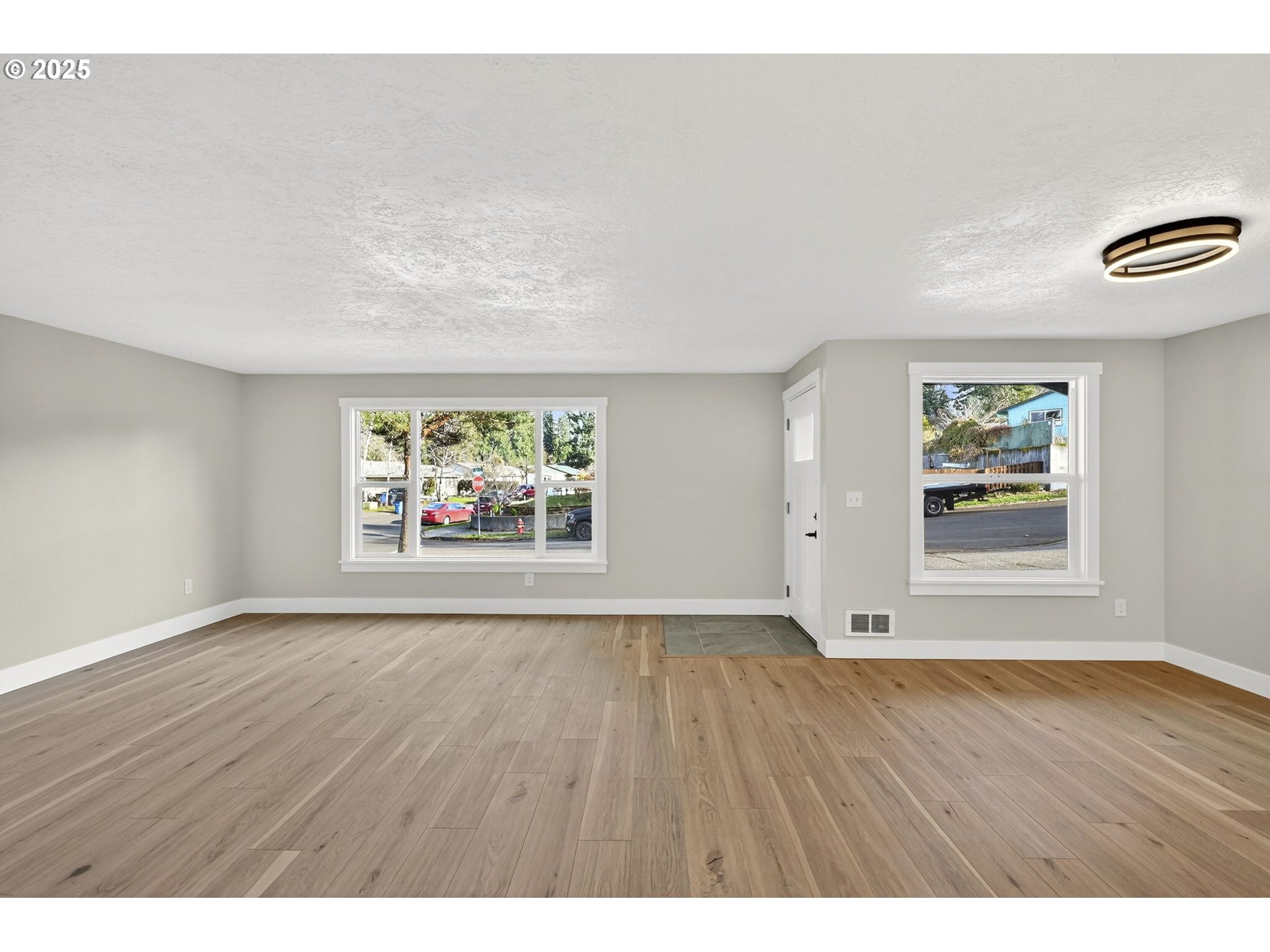 17745 Davis Drive Sandy, OR 97055 - Photo 6 of 44 a view of an empty room with a window and wooden floor