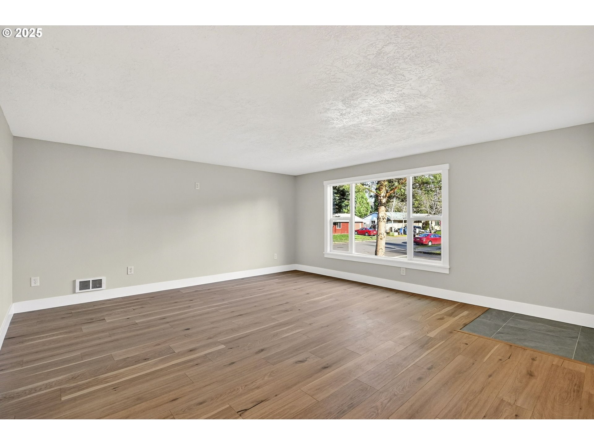 17745 Davis Drive Sandy, OR 97055 - Photo 8 of 44 a view of an empty room with window and wooden floor