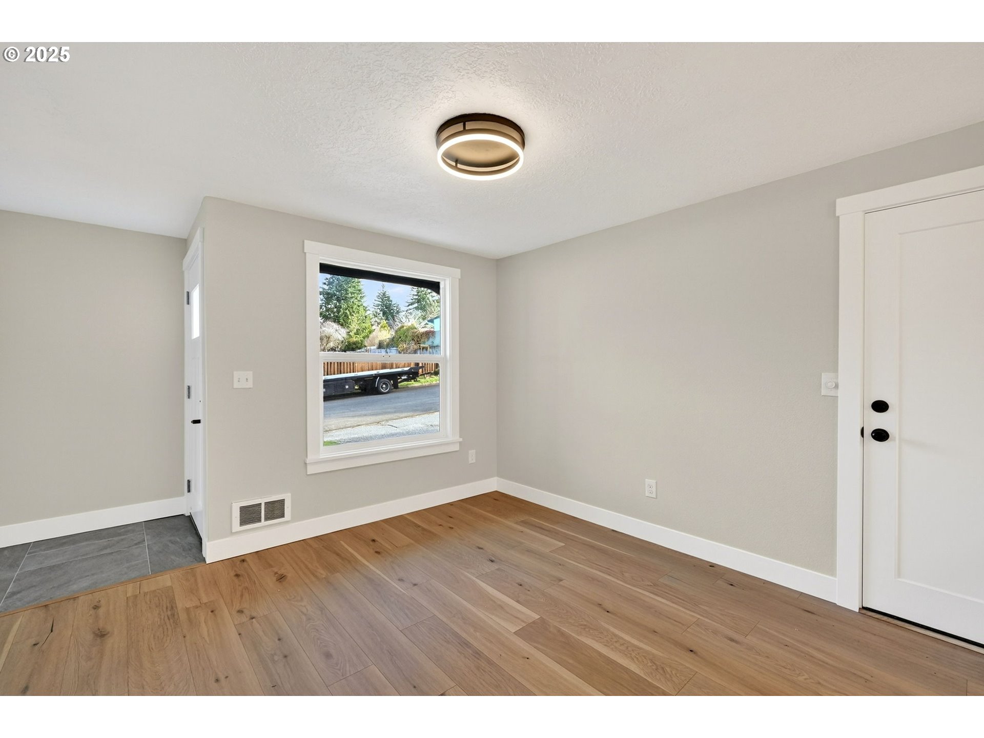 17745 Davis Drive Sandy, OR 97055 - Photo 10 of 44 a view of an empty room with wooden floor and a window