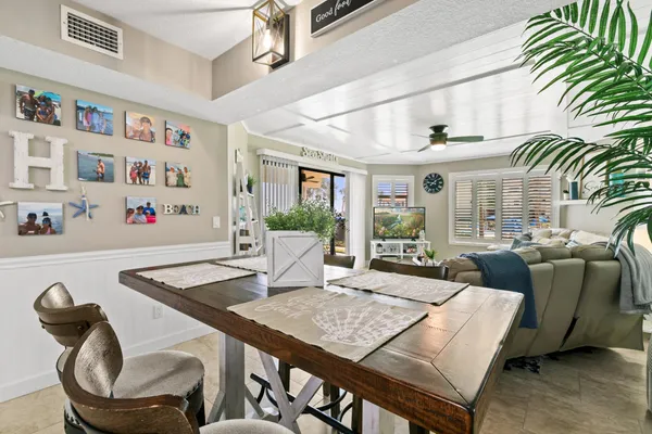 a living room with furniture flat screen tv and a large window
