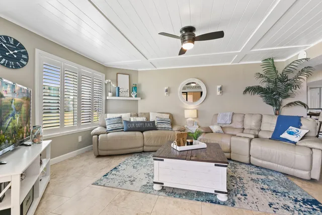 a bedroom with a bed a couch and a flat screen tv