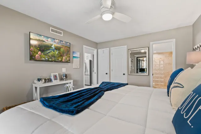 a bedroom with bed and wooden floor