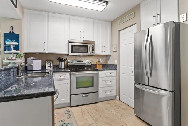 a stove top oven sitting inside of a kitchen