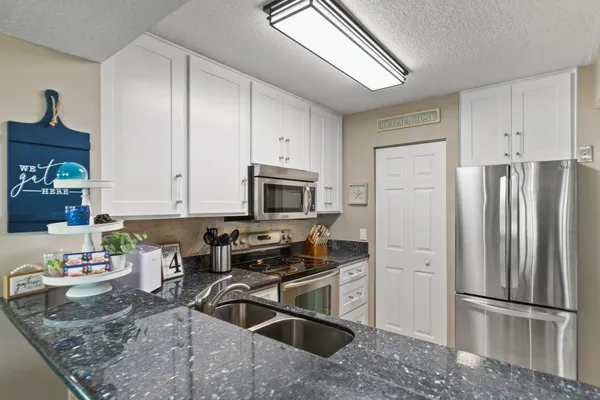 a kitchen with a sink and a refrigerator