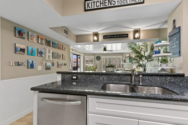 a dining room with furniture and a floor to ceiling window