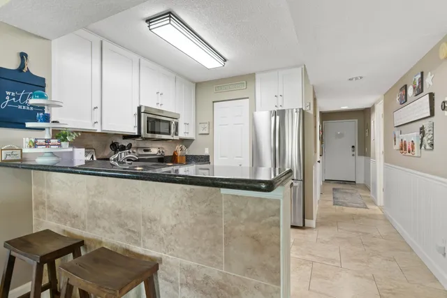 a view of a dining room with furniture and window