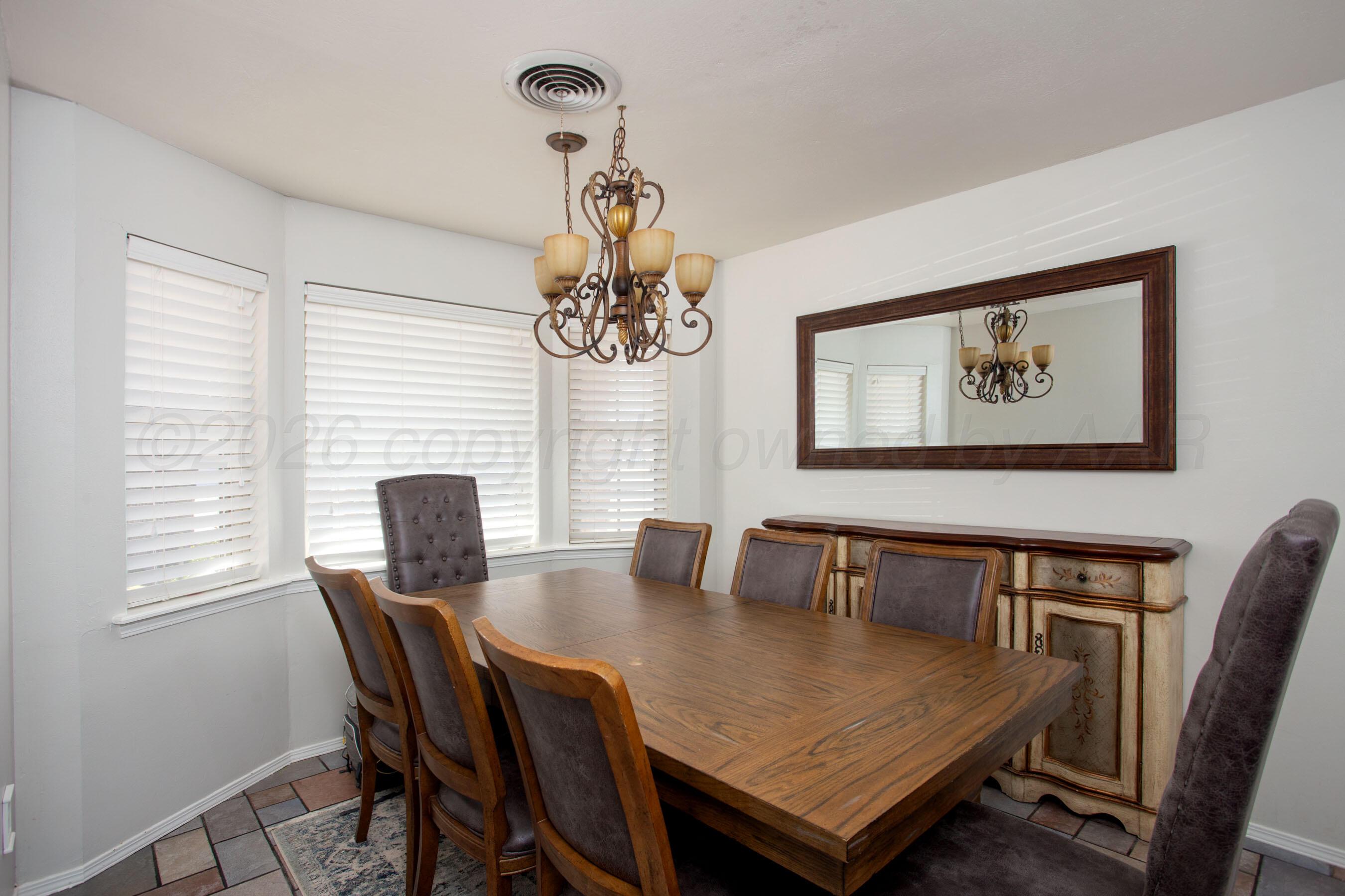 7924 Simpson Drive Amarillo, TX 79121 - Photo 11 of 33 a view of a dining room with furniture window and wooden floor