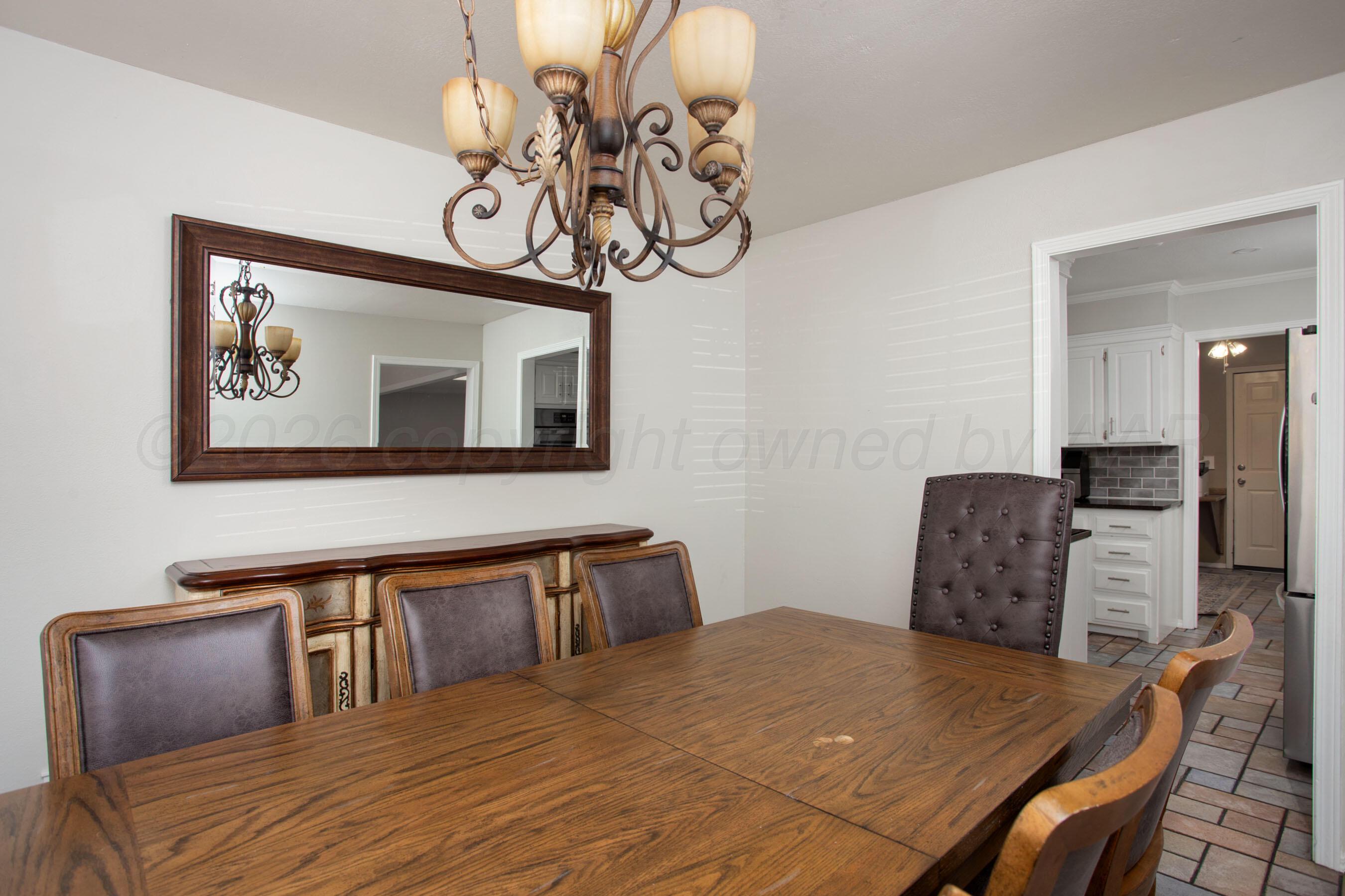 7924 Simpson Drive Amarillo, TX 79121 - Photo 12 of 33 a bedroom with a bed and a chandelier