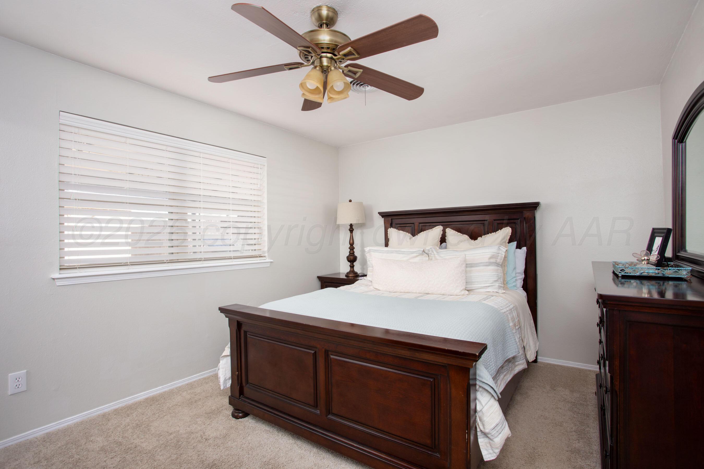 7924 Simpson Drive Amarillo, TX 79121 - Photo 13 of 33 a bedroom with a bed and a ceiling fan