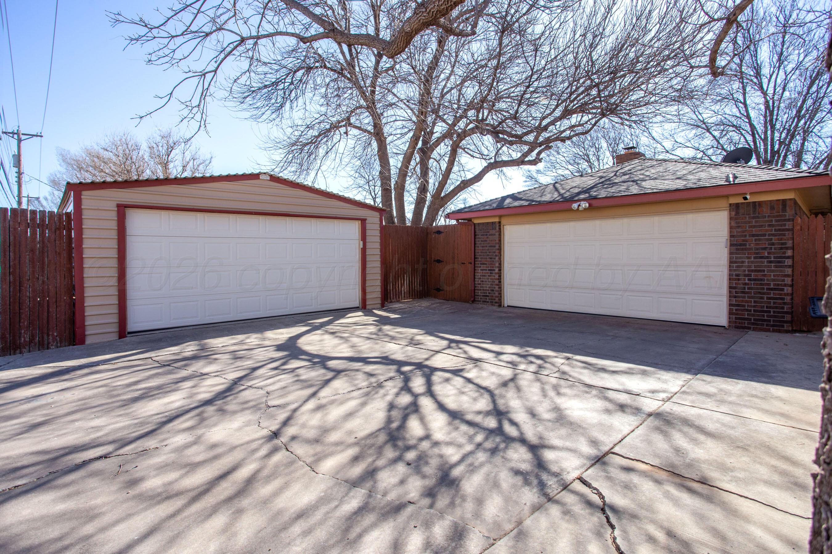 7924 Simpson Drive Amarillo, TX 79121 - Photo 3 of 33 a front view of a house with a yard and garage