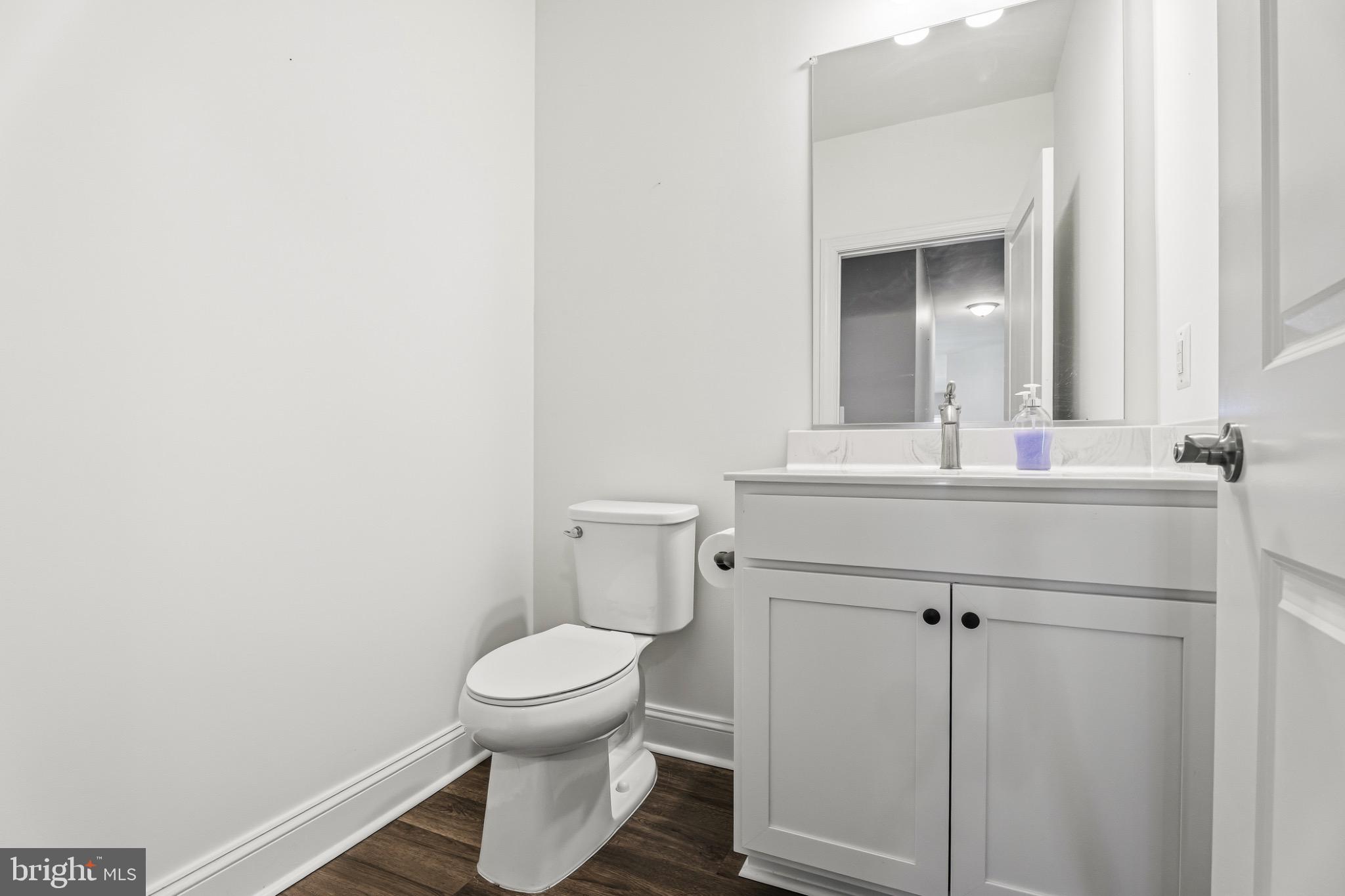 406 Bold Ruler Court, Unit 402 Havre de Grace, MD 21078 - Photo 12 of 49 a bathroom with a toilet sink and mirror