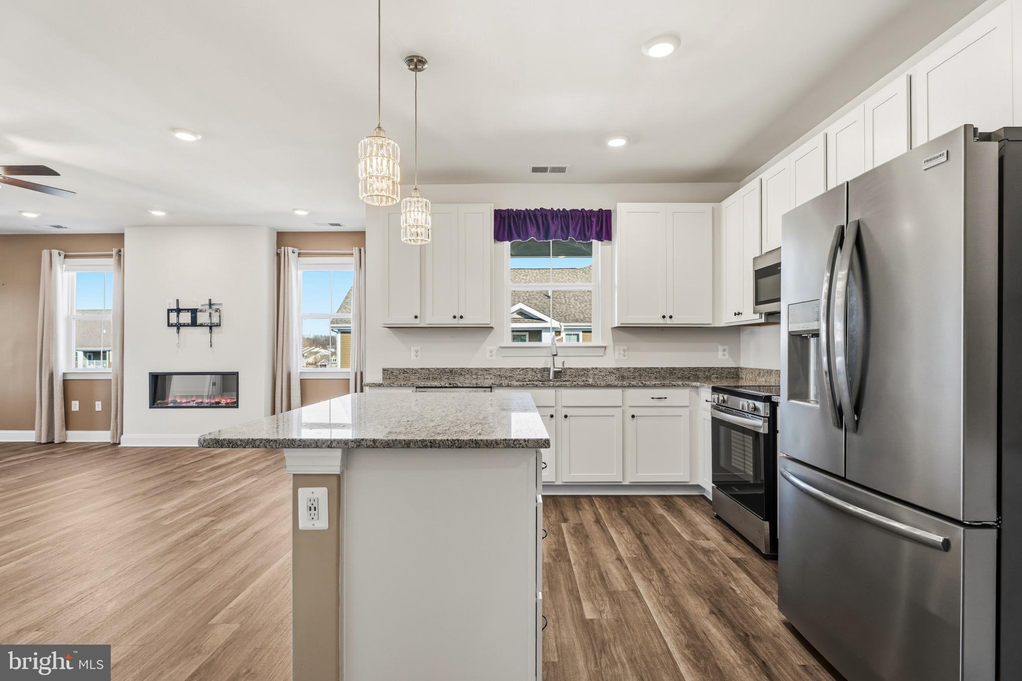 406 Bold Ruler Court, Unit 402 Havre de Grace, MD 21078 - Photo 14 of 49 a kitchen with stainless steel appliances granite countertop a refrigerator and a stove top oven