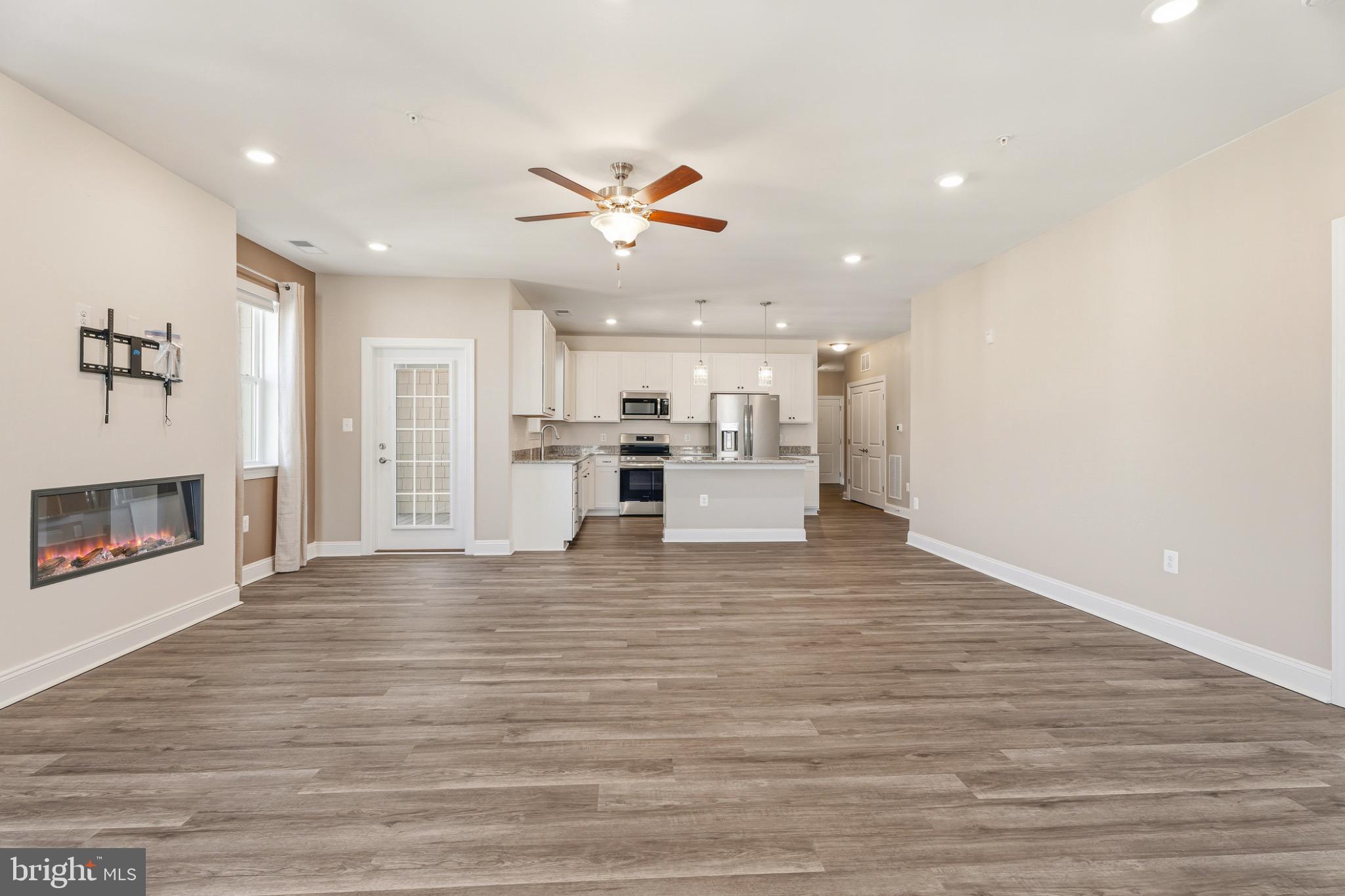 406 Bold Ruler Court, Unit 402 Havre de Grace, MD 21078 - Photo 22 of 49 a view of kitchen with a refrigerator a ceiling fan and wooden floor