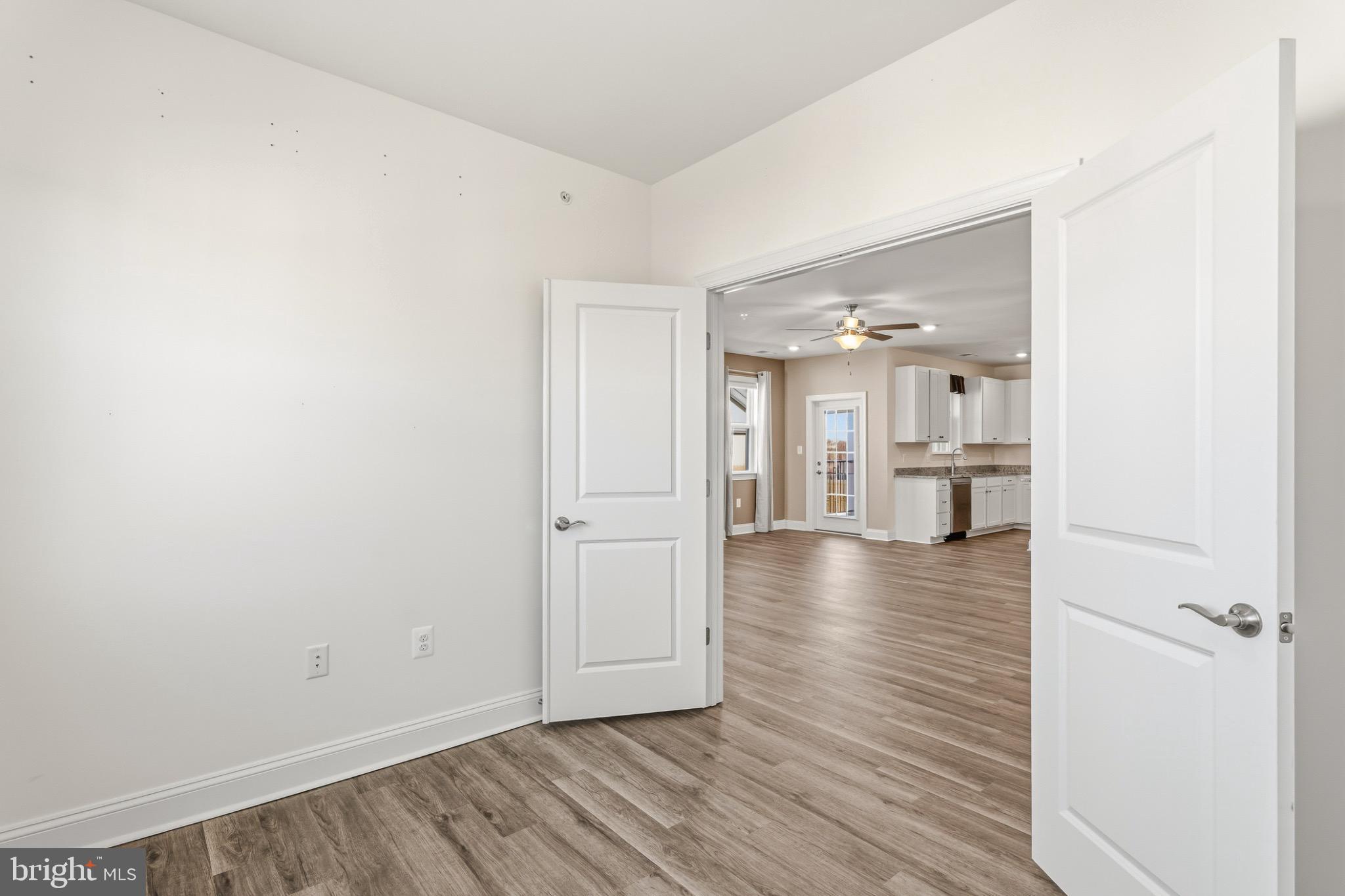 406 Bold Ruler Court, Unit 402 Havre de Grace, MD 21078 - Photo 23 of 49 a view of a room with wooden floor and a kitchen