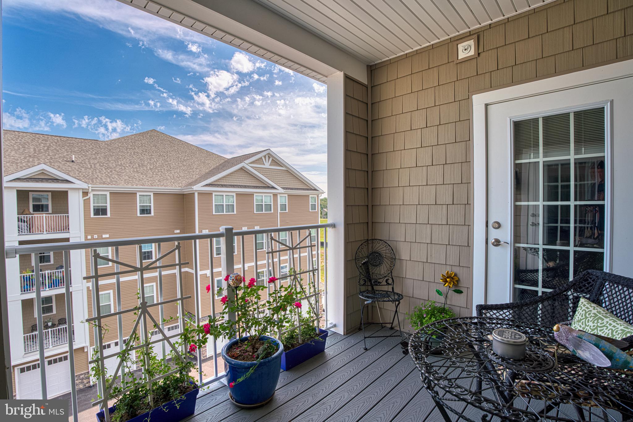 406 Bold Ruler Court, Unit 402 Havre de Grace, MD 21078 - Photo 30 of 43 Charming balcony with vibrant blooms and views.