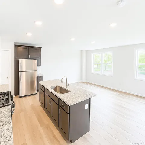 a kitchen with a stove a refrigerator a sink and a microwave