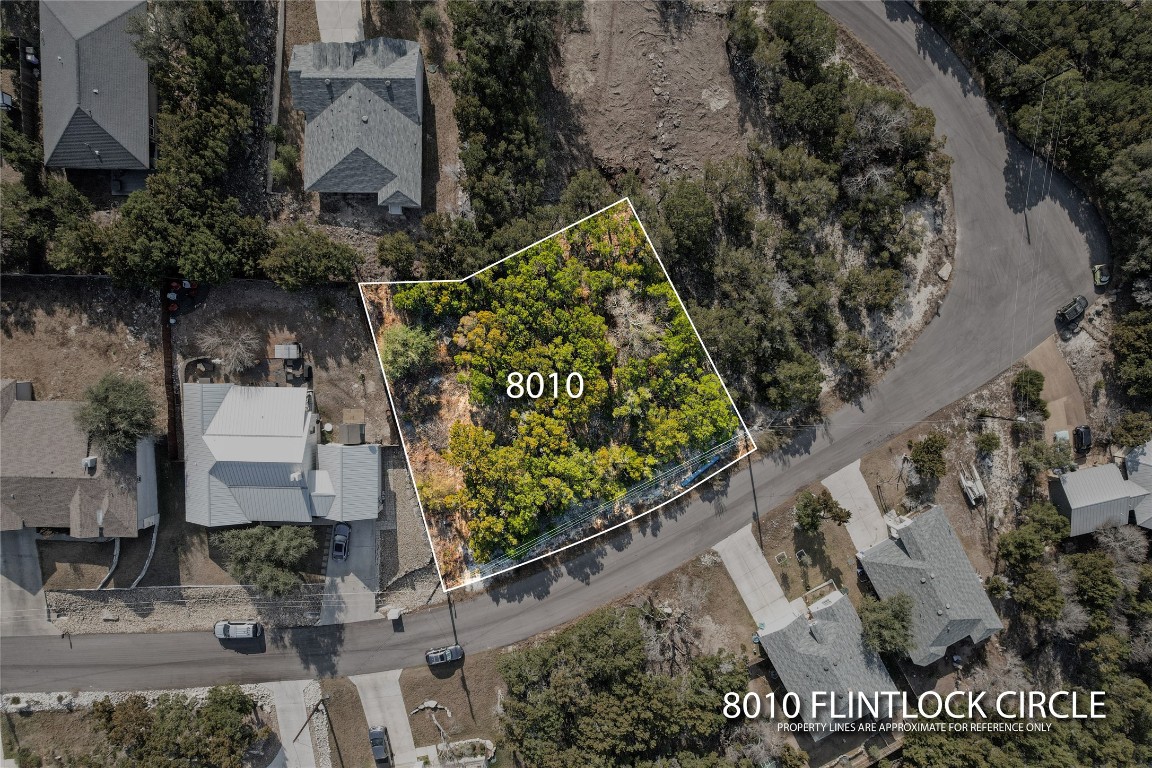 8010 Flintlock Circle Lago Vista, TX 78645 - Photo 14 of 15 an aerial view of a house with a yard and large trees