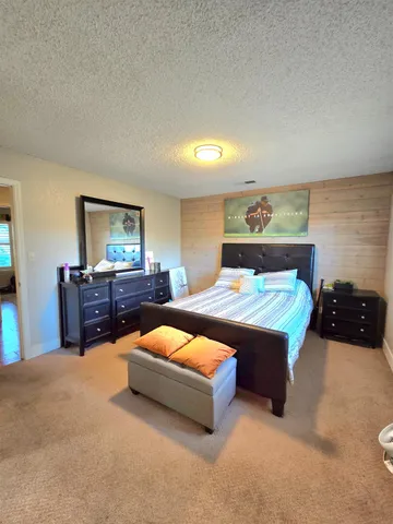 a bedroom with a bed and a flat screen television