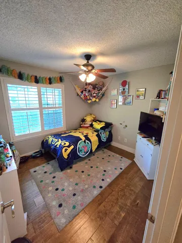 a bedroom with furniture and a chandelier
