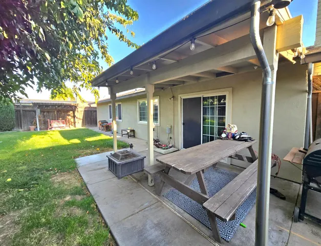 a view of a patio with couches table and chairs and garden