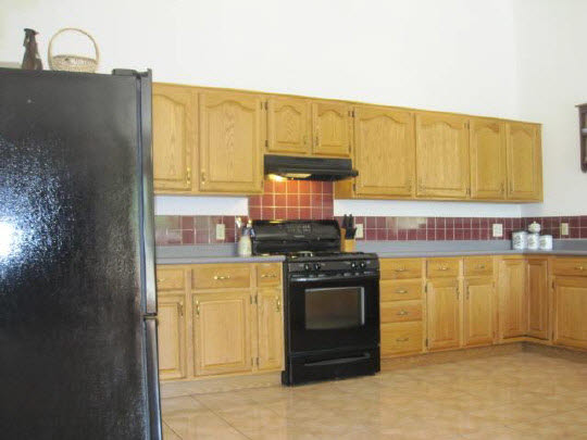 6966 North Marrill Road Byron, IL 61010 - Photo 5 of 11 a kitchen with stainless steel appliances granite countertop a stove a sink and a microwave