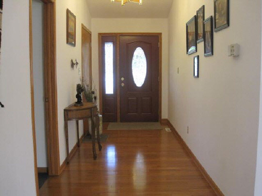 6966 North Marrill Road Byron, IL 61010 - Photo 9 of 11 a view of a hallway with wooden floor and closet