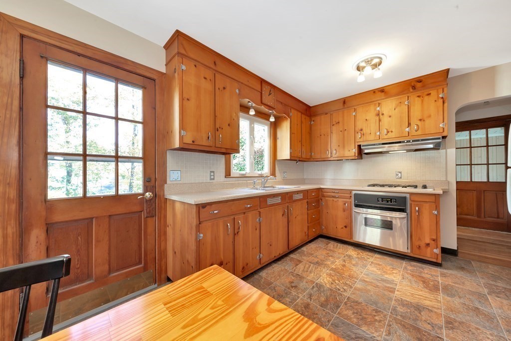 8 Tower Road Lexington, MA 02421 - Photo 16 of 39 a kitchen with stainless steel appliances granite countertop a stove a sink dishwasher and a refrigerator