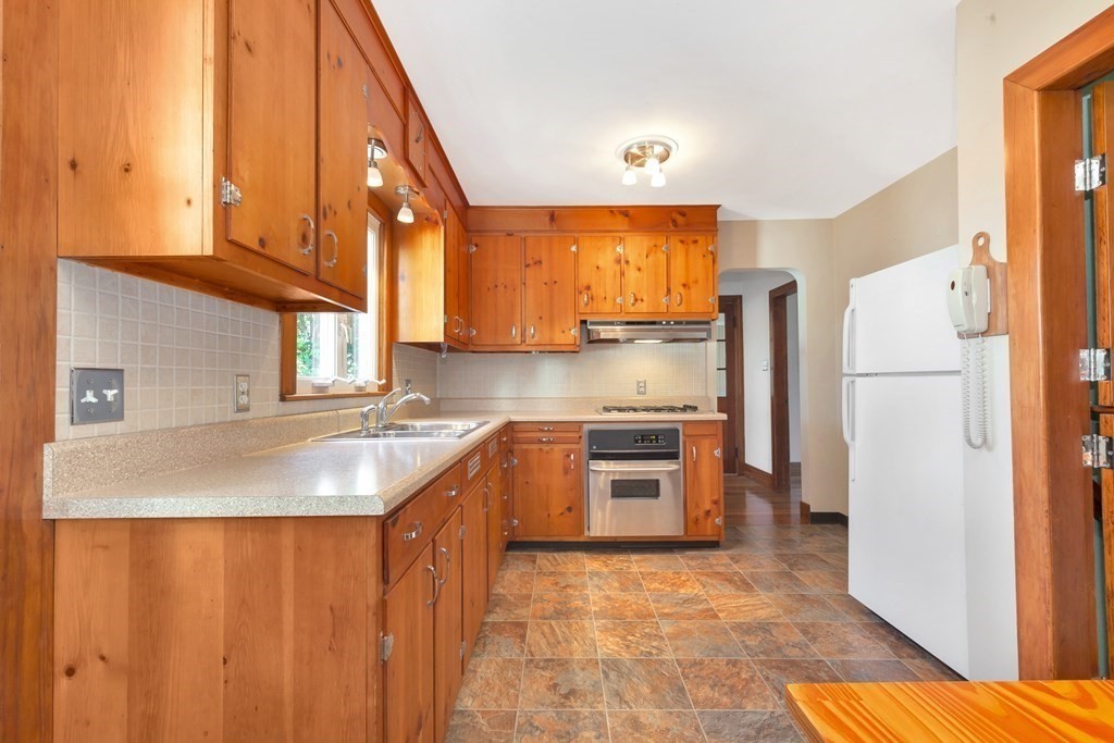 8 Tower Road Lexington, MA 02421 - Photo 17 of 39 a kitchen with stainless steel appliances granite countertop a refrigerator and a sink