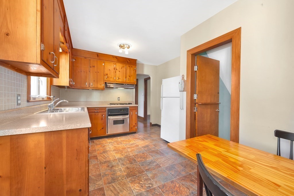 8 Tower Road Lexington, MA 02421 - Photo 18 of 39 a kitchen with stainless steel appliances granite countertop a sink a stove and a refrigerator