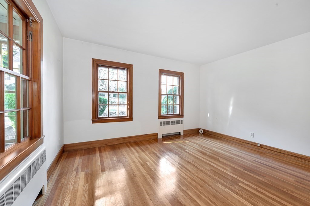 8 Tower Road Lexington, MA 02421 - Photo 19 of 39 a view of an empty room with wooden floor and a window